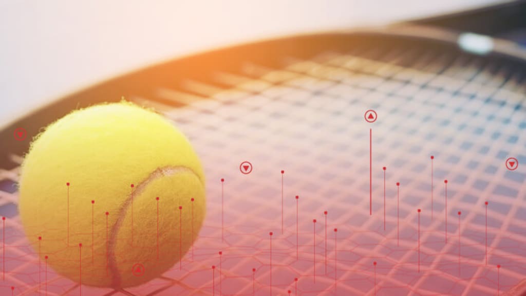 close up image of a tennis ball sitting on a racket