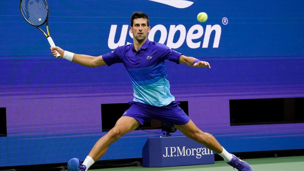 Novak Djokovic hitting a return during a tennis match at the US Open.